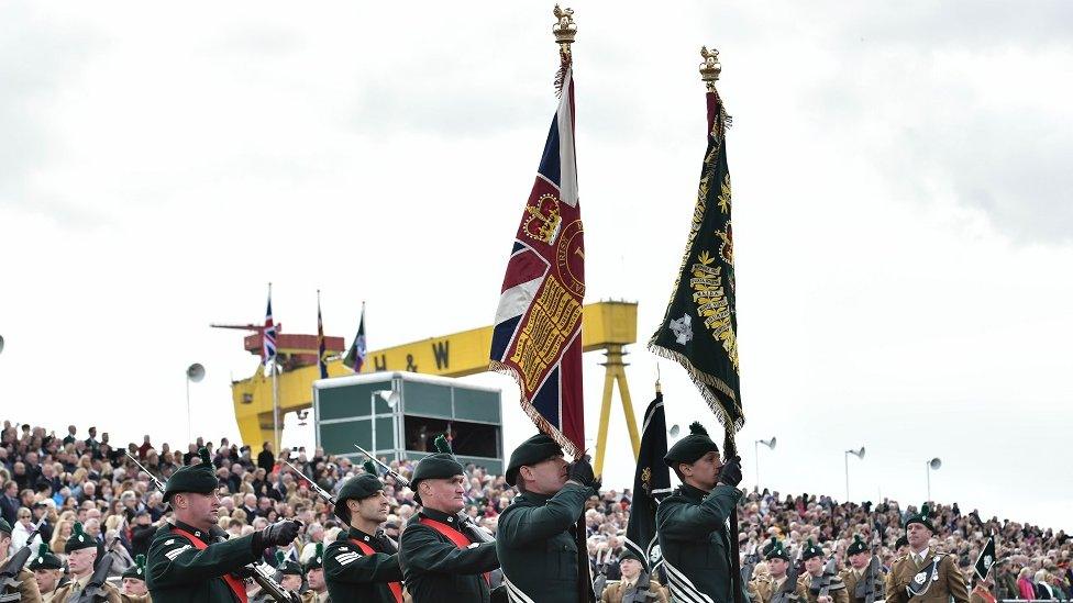 soldiers march past the Harland and wolf signs