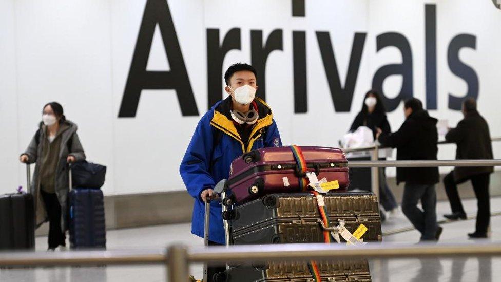 People arriving from China in London on Wednesday. The UK - outside the EU - is asking for a pre-departure tests for Chinese arrivals from tomorrow