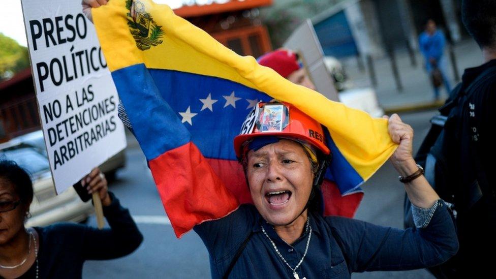 Venezuelan opposition activists carry out a peaceful demonstration