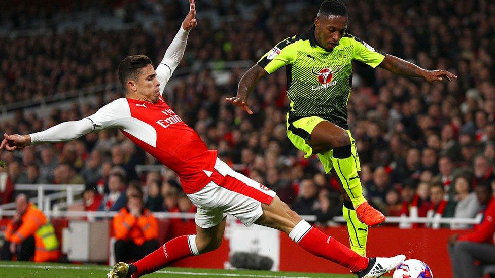 Gabriel of Arsenal (L) tackles Callum Harriott of Reading (R) during the EFL Cup fourth round match between Arsenal and Reading