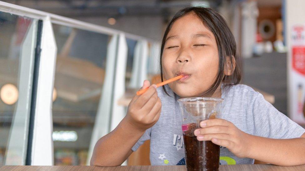 Child with a sugary drink