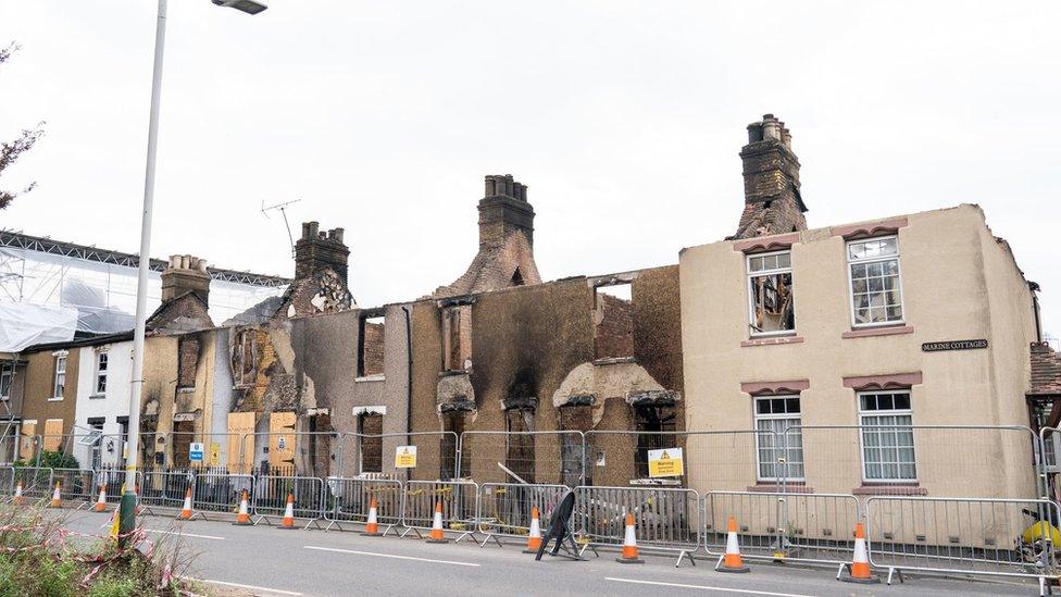 A row of fire damaged terraced houses in Wennington