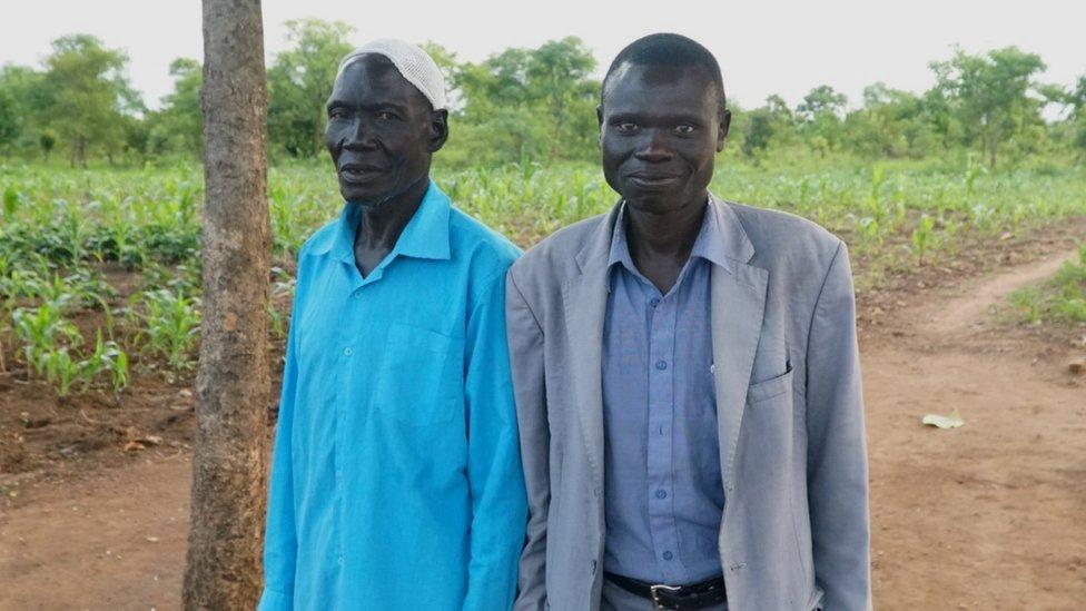 Issa Agub (L) and the refugee he gave land to pictured in Uganda