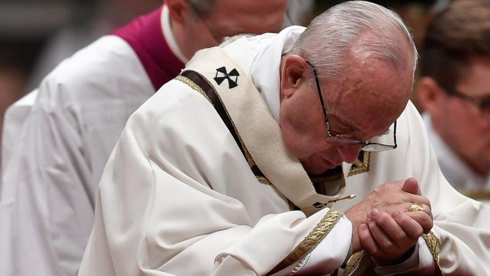 Pope Francis prays during a Christmas Eve Mass at St Peter's Basilica in the Vatican. Photo: 24 December 2017