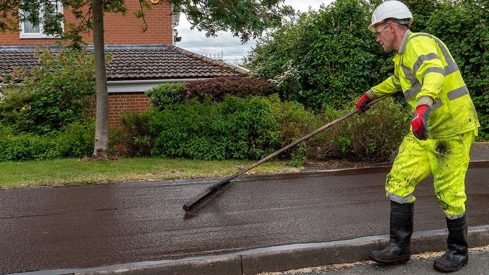 Man laying asphalt