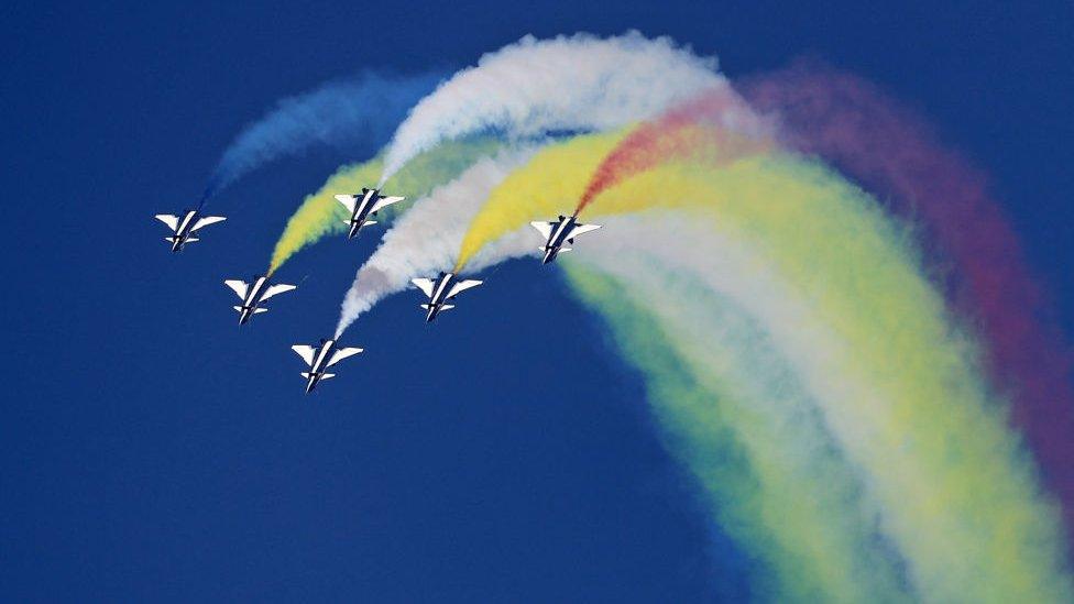 Chengdu J-10 fighter jets from the Chinese August 1st aerobatic team perform during the Dubai Airshow on November 14, 2017