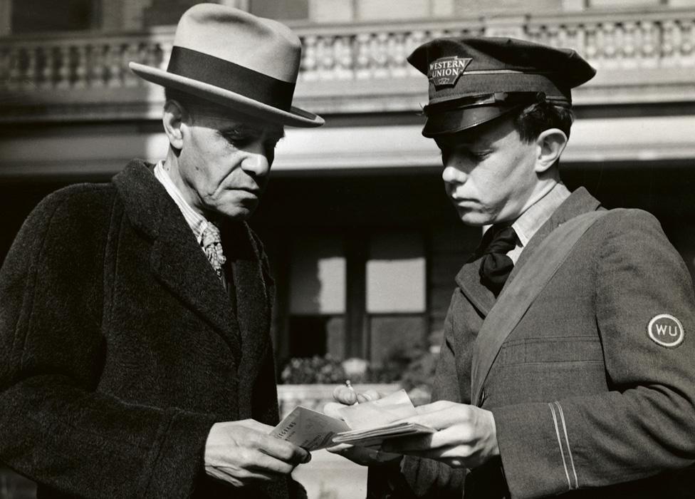 A Western Union messenger delivering a telegram, circa 1900.