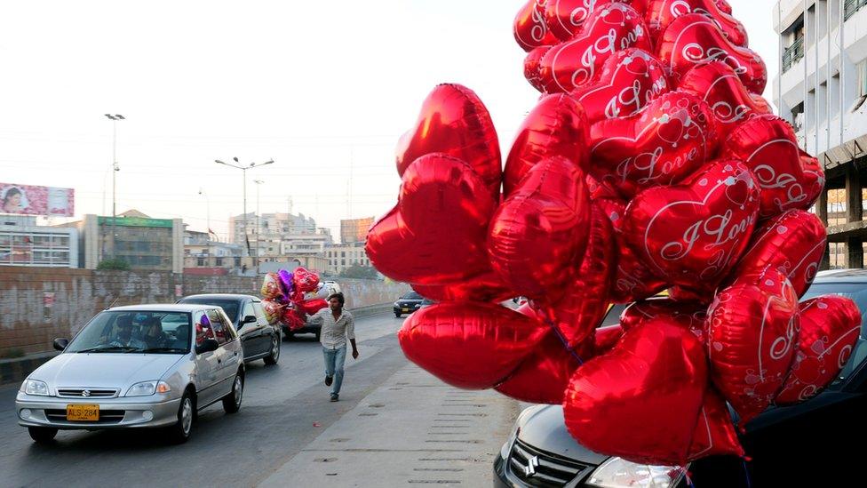 File photo: Heart shaped balloons on a street in Karachi, 14 February 2011