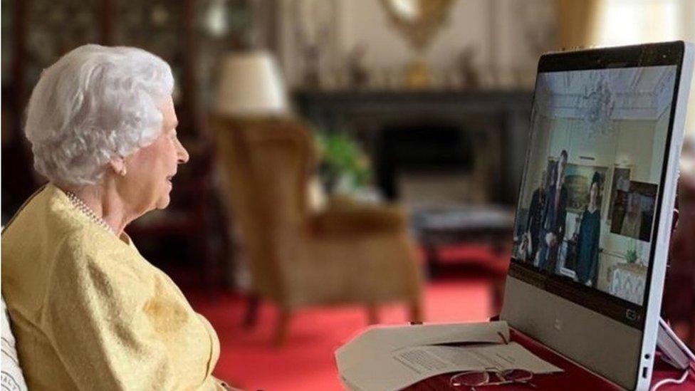 Queen Elizabeth II looks at a computer screen