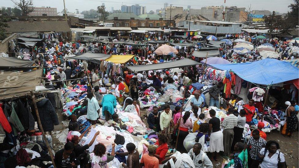 People walk around Gikomba Market, East Africa's biggest second-hand clothing market, on July 10, 2014 in Nairobi.