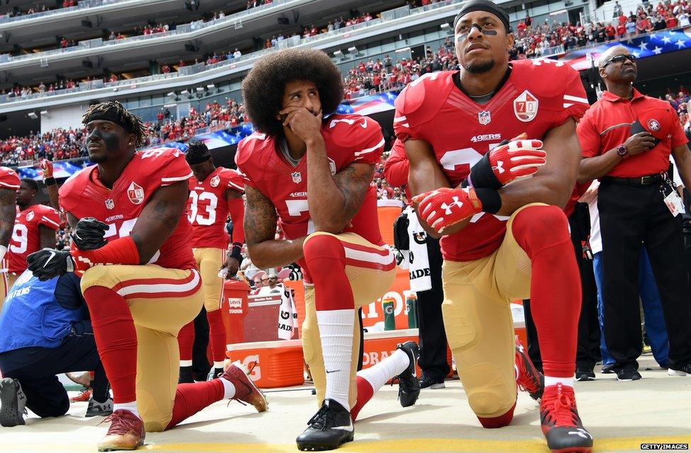 Colin Kaepernick kneeling during the American national anthem