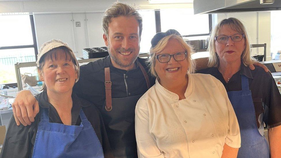 Three school chefs standing with chef Rob Roy Cameron