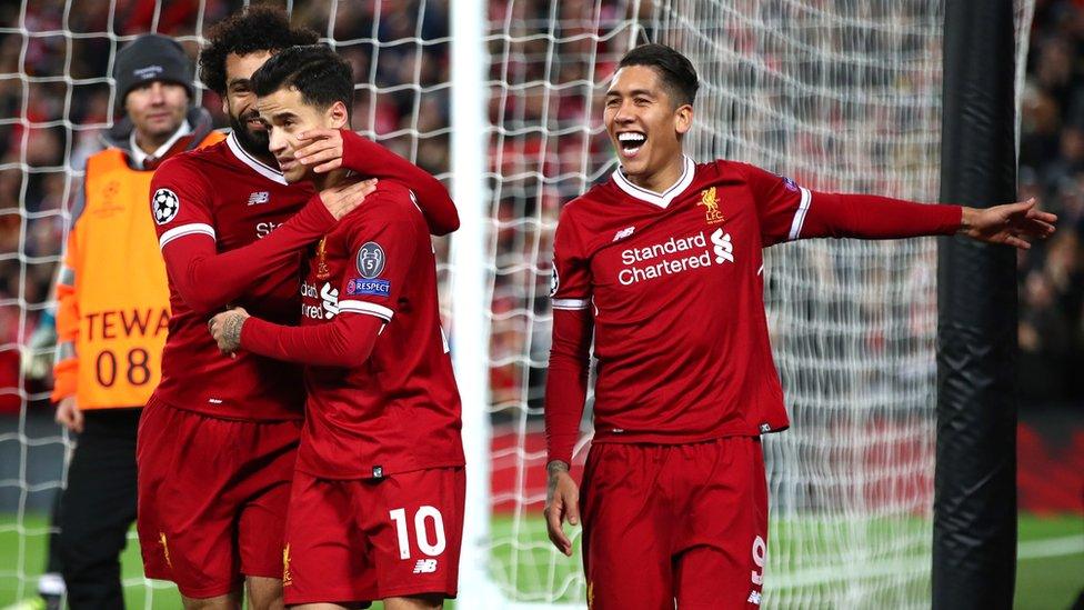 Philippe Coutinho of Liverpool celebrates after scoring his sides fifth goal with Mohamed Salah of Liverpool and Roberto Firmino of Liverpool during the UEFA Champions League group E match between Liverpool FC and Spartak Moscow at Anfield on December 6, 2017 in Liverpool