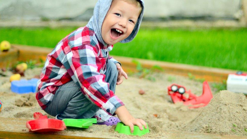 child playing in sandpit