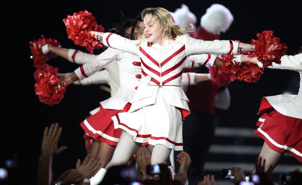 Madonna performs on stage with dancers in Nice southeastern France, as part of her MDNA world tour