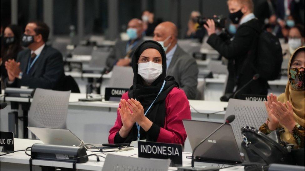 Delegates applaud during the opening ceremony for COP26