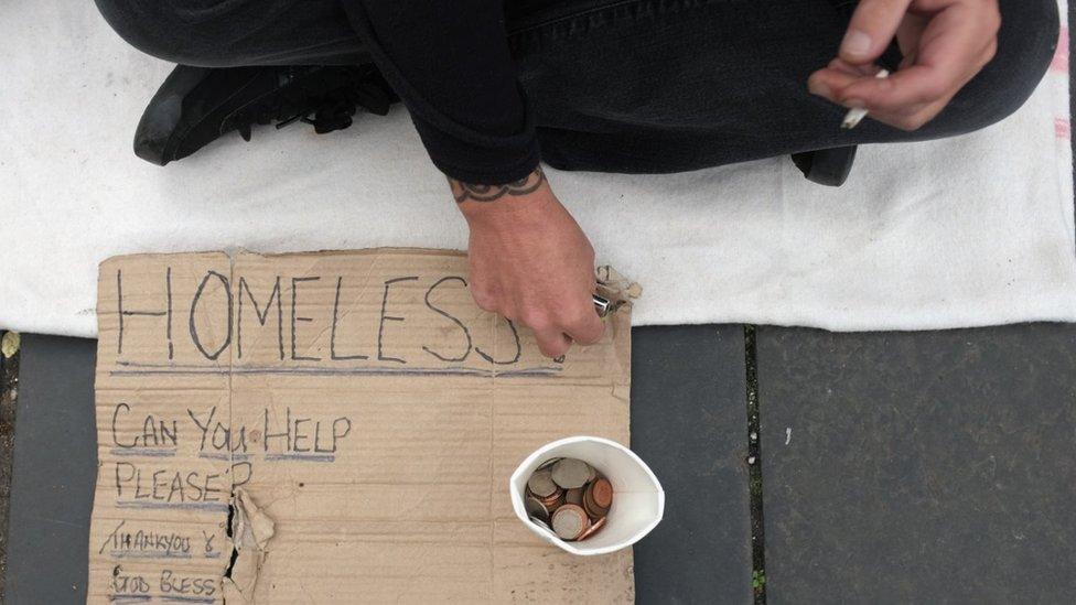 Homeless person with sign