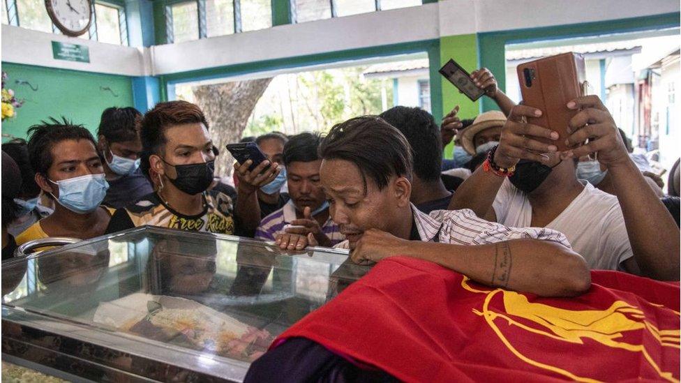 Family members and relatives attend the funeral ceremony of 13 year-old Sai Wai Yan, who was shot dead while playing outside his house in Yangon