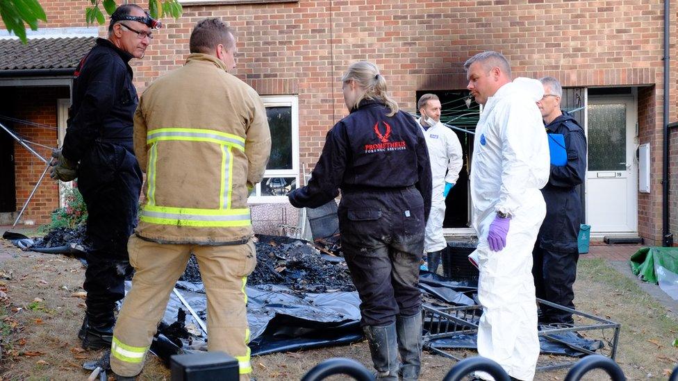 Investigators at the fire scene