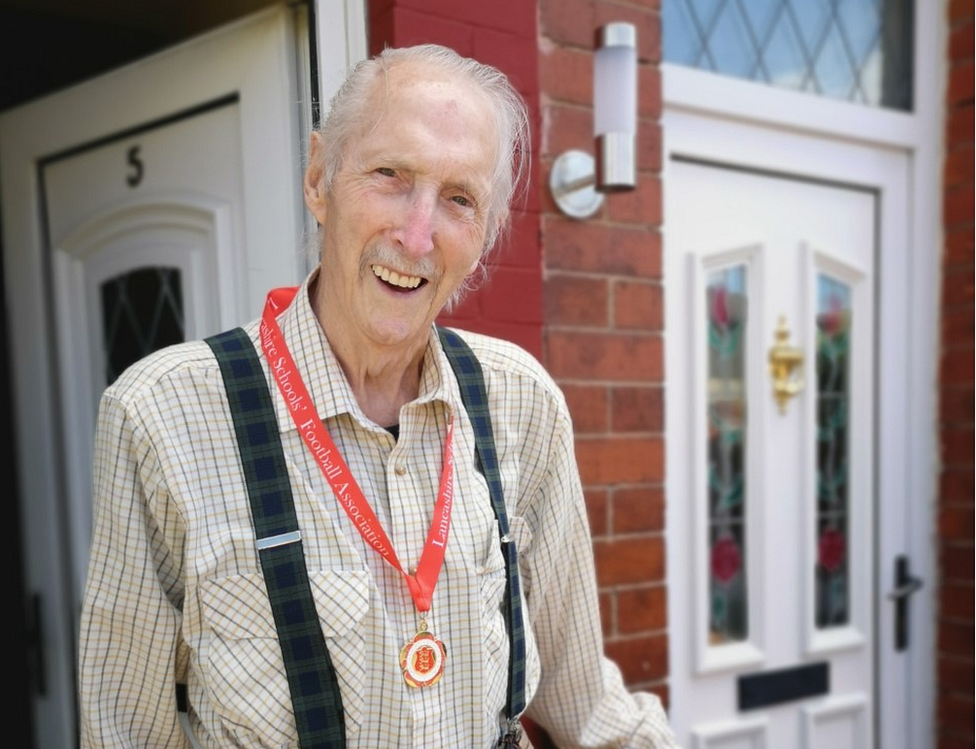 John Zelly proudly wears his medal