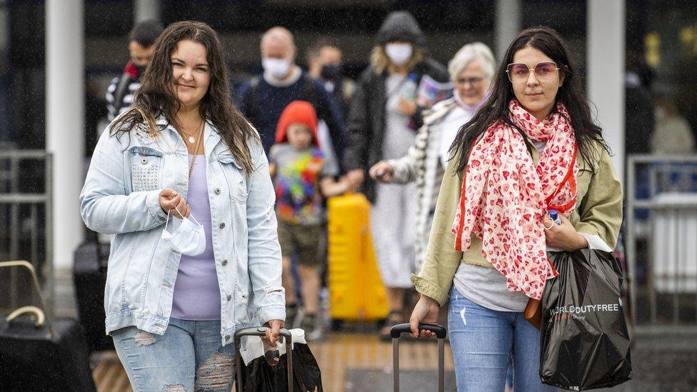 Passengers leaving Belfast International Airport on Monday after arriving on a flight from Barcelona