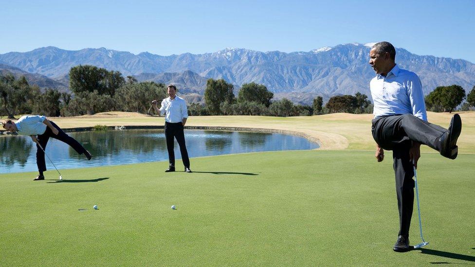 Obama kicks a leg in frustration, while exclaiming, on a putting green with two other players