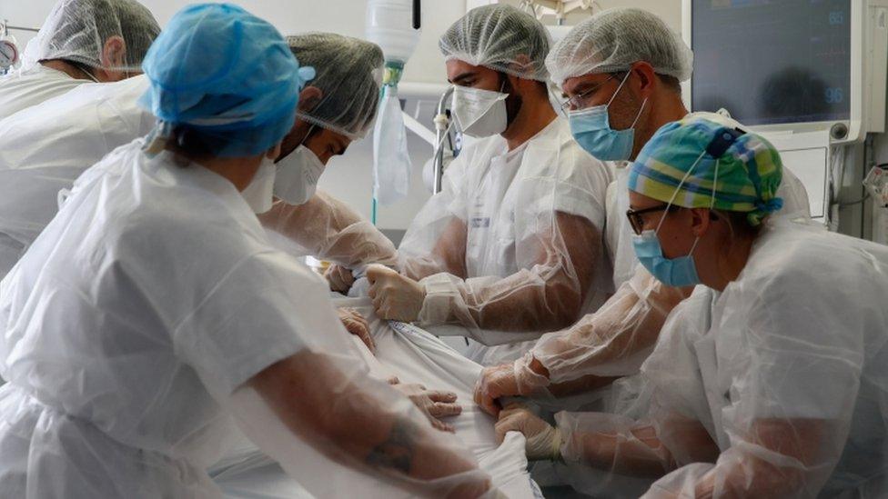 Medical workers treat a patient suffering from the coronavirus disease at a hospital in France