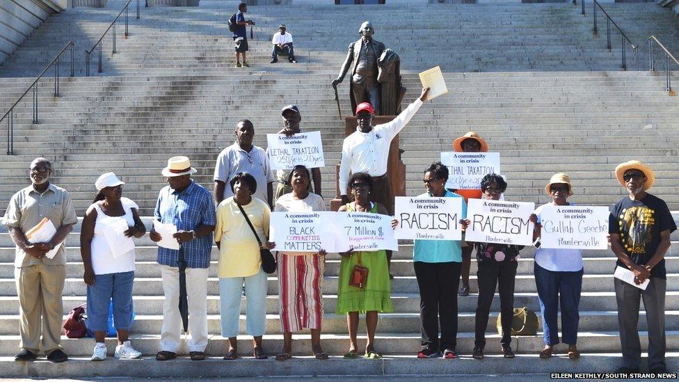 Plantersville residents protest on the steps of the Capitol in Clumbia