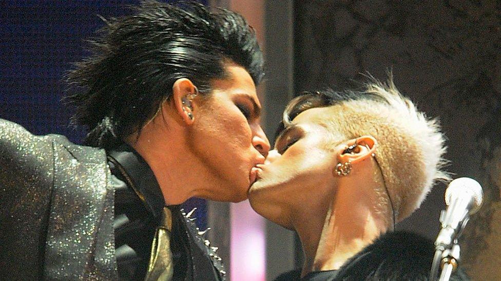 Adam Lambert kisses his band's bassist