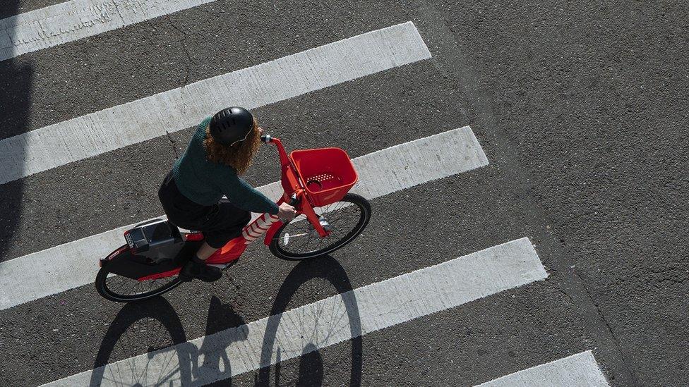 A woman riding a Jump Bike