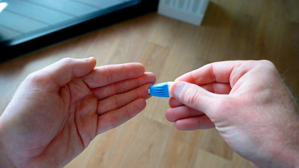 A person doing a finger prick test