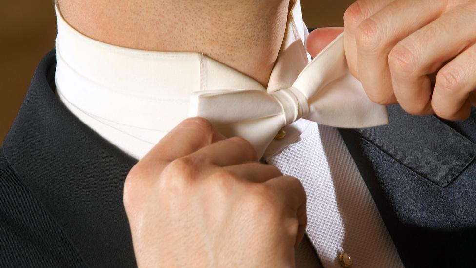 Man wearing white bow tie