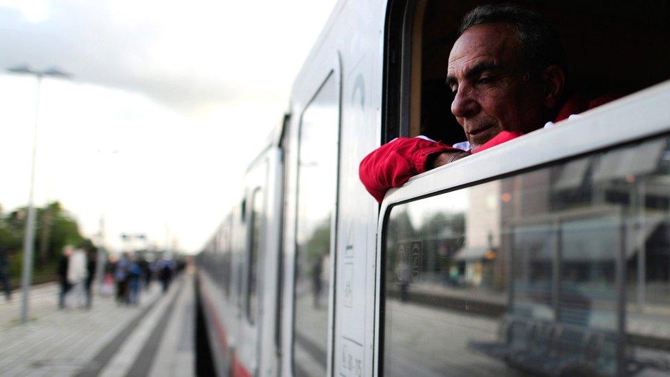 A Syrian refugee looks out of train window on arrival at the train station in Celle, Germany