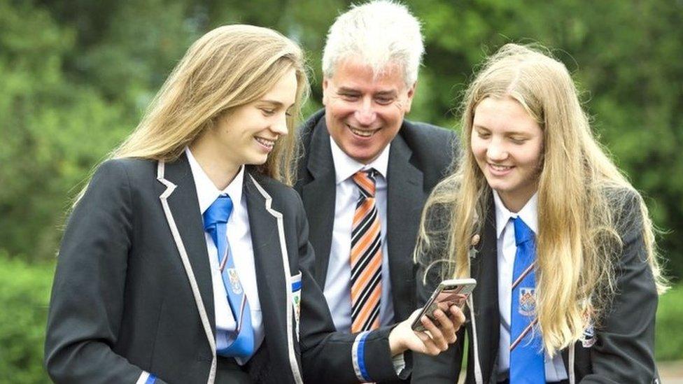 Eastwood High School pupils Clare Wallace (right) and Erin Wallace with head teacher Stuart Maxwell