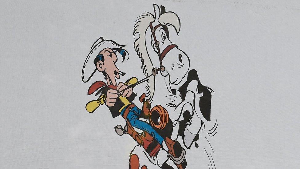 An illustration of cartoon cowboy Lucky Luke on his horse