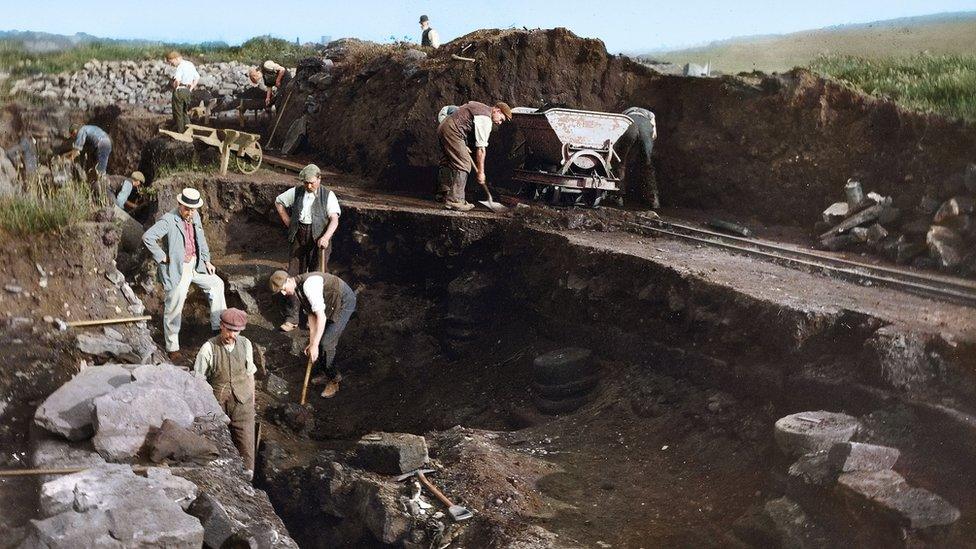 Workers excavate big hole