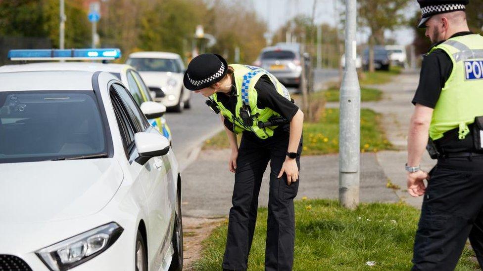 Two Cheshire Police officers pull over a car