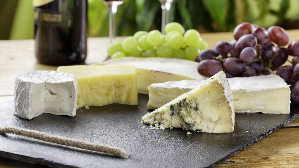 Cheeseboard on a table with grapes