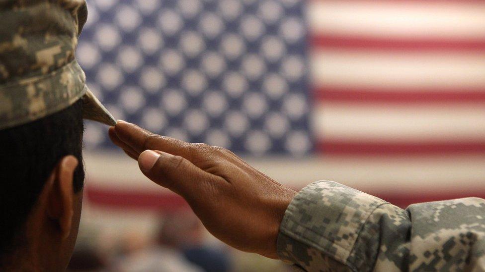 A US soldier salutes the flag (file photo)