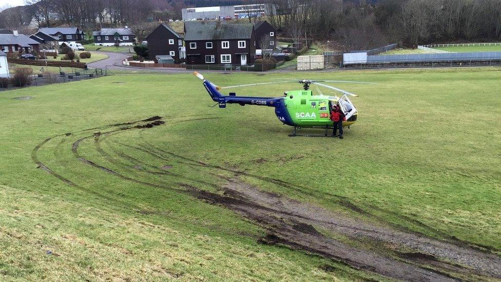 Helicopter on muddy field