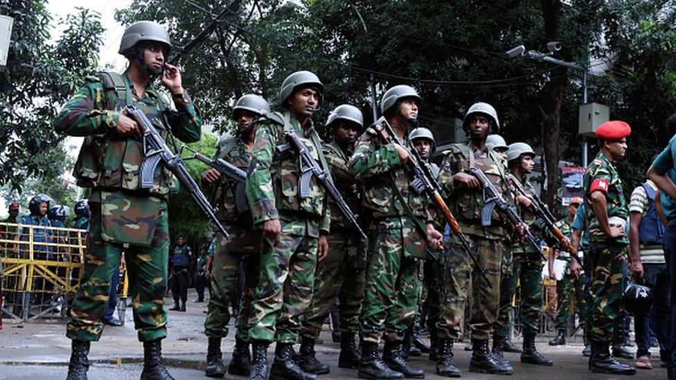 Bangladeshi soldiers stand guard in the capital Dhaka