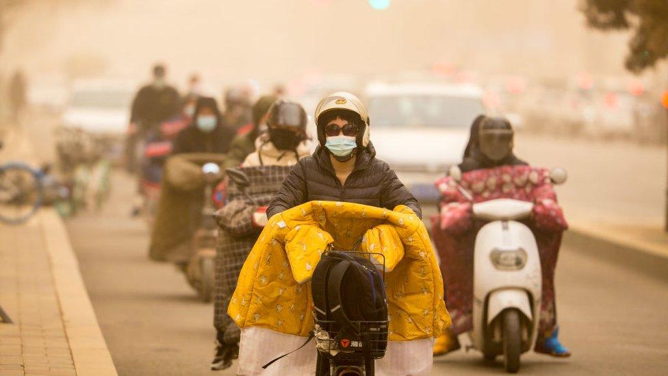 Citizens ride motorbikes in sandstorm on March 15, 2021 in Hohhot, Inner Mongolia Autonomous Region of China.