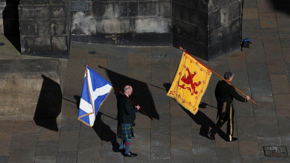 A Lion Rampant and a Saltire are carried into St Giles' Cathedral in Edinburgh ahead of the thanksgiving service for Queen Elizabeth