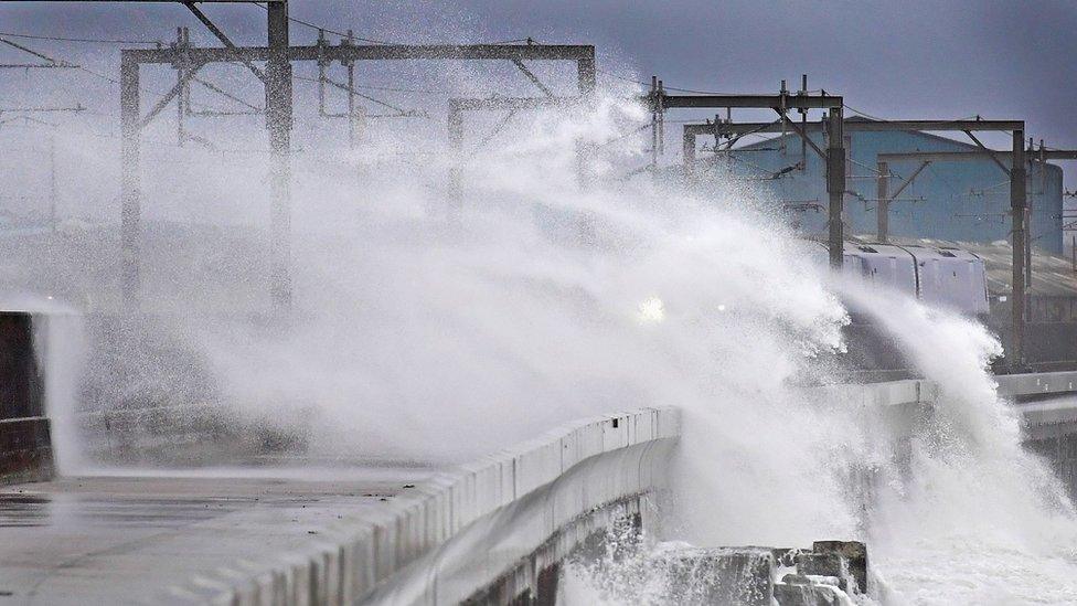 Train passes through waves at Saltcoats in North Ayrshire