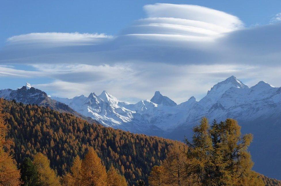 Clouds above mountains and forests