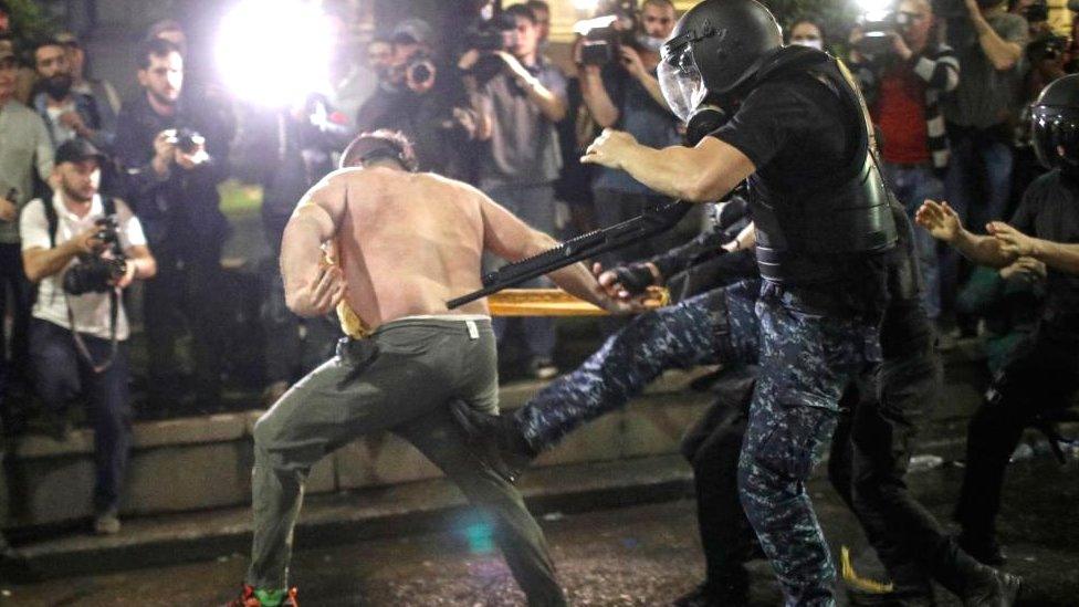 An opposition party supporter clashes with riot police during a protest against a draft bill on 'foreign agents' near the Parliament in Tbilisi, Georgia, 01 May 2024