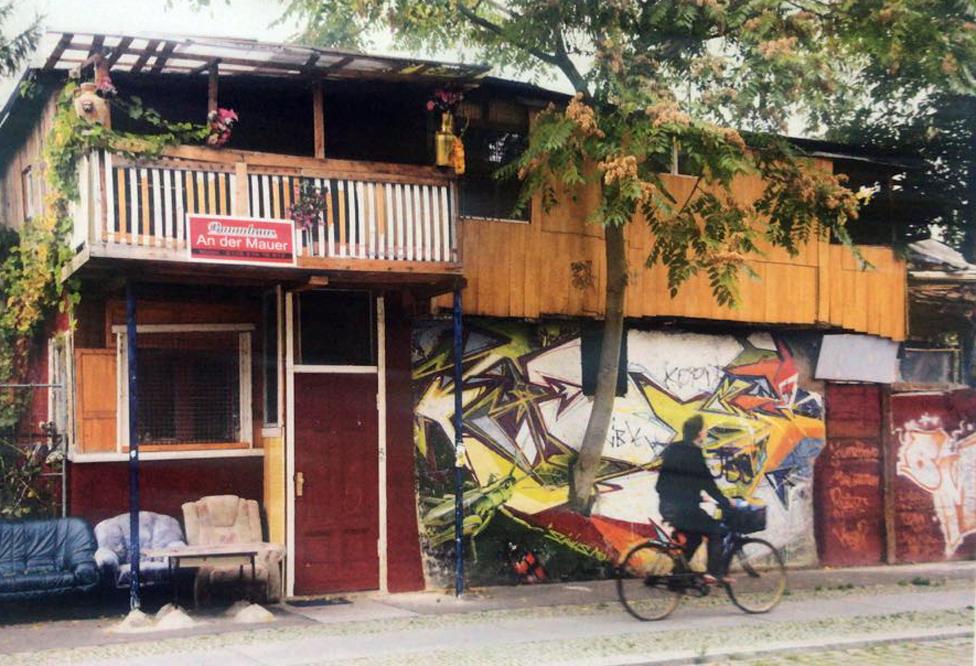 man cycles past house