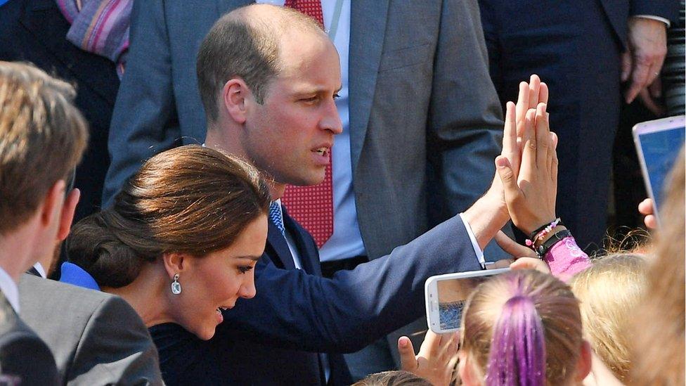 Prince William high fives a member of the crowd