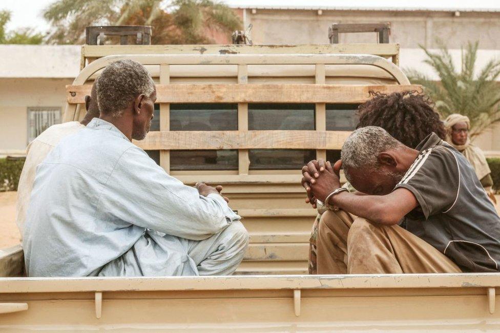 A group of captured Fact rebels are seen handcuffed in the back of a pick-up truck as they are displayed together with their confiscated weapons and vehicles at the headquarters of the Chadian Army in N'Djamena on Sunday.