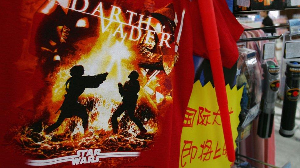 T-shirts and other souvenirs of the movie 'Star Wars: Episode III - Revenge of the Sith' are displayed for sale at a newly opened Wal-Mart supermarket May 19, 2005 in Beijing, China.